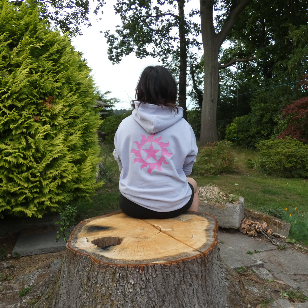 Person sitting on a tree stump in a garden setting